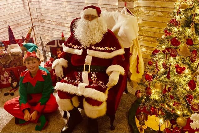 Santa and one of his elves at the Christmas grotto in Staffa Walk