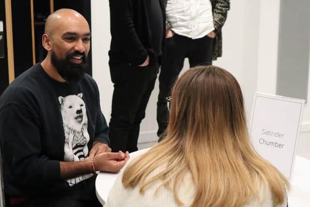 Satinder Chumber speaks with attendee at networking event.