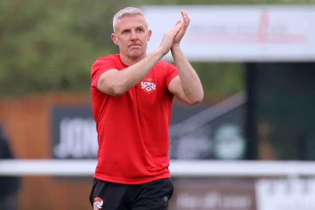 Richard Lavery applauds the travelling supporters after Kettering's 1-0 win at Biggleswade on Easter Monday