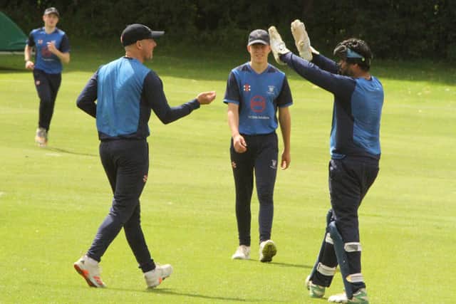 Wollaston celebrate a wicket during their semi-final win over Kettering