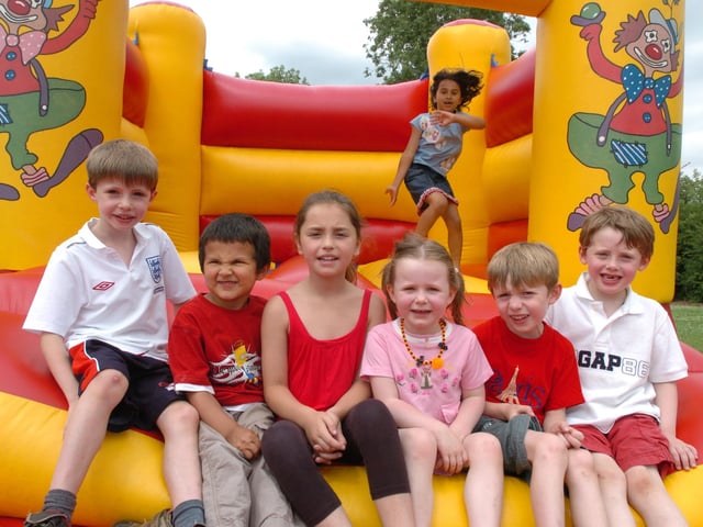 Lucy Murphy, seven, Alex Loom, seven, Alexander Murphy, four, Brooke Willis, eight, Evie Fawkes, four, Ciaran Loom, five, and Noah McCahill, five, enjoy the bouncy castle, July 2009