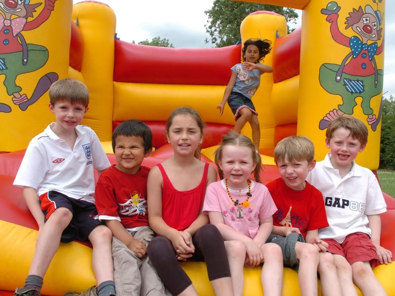 Lucy Murphy, seven, Alex Loom, seven, Alexander Murphy, four, Brooke Willis, eight, Evie Fawkes, four, Ciaran Loom, five, and Noah McCahill, five, enjoy the bouncy castle, July 2009