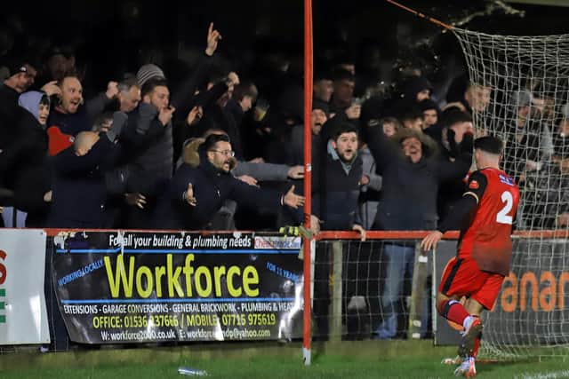 Frankie Maguire celebrates in front of the delighted Kettering Town fans after scoring the equaliser in Tuesday's remarkable 3-2 win over Boston United. Pictures by Peter Short
