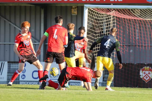Kyle Hammond (no.4) is about to score the winning goal for Needham Market (Picture: Peter Short)
