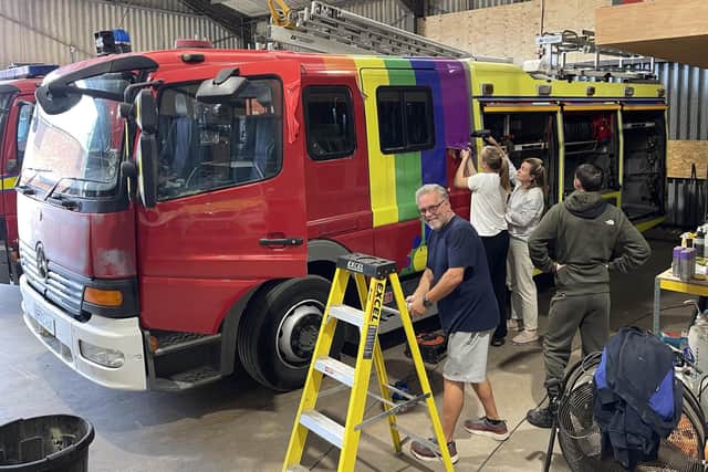 The fire engine in the process of having its stickers removed
