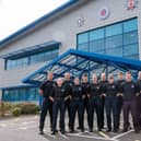 Twelve new firefighters stood outside NFRS HQ
