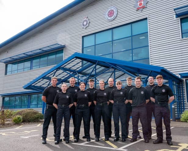 Twelve new firefighters stood outside NFRS HQ