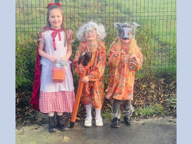 Lyla, age 7, as Little Red Riding Hood, Arabella, age 6, as Grandma, and Rayna, age 5, as the Big Bad Wolf