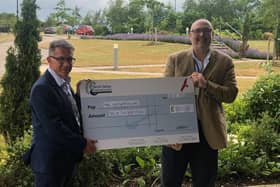 Iain Smith of Nene Valley Crematorium presented a cheque to MIND's Dion Hunt.