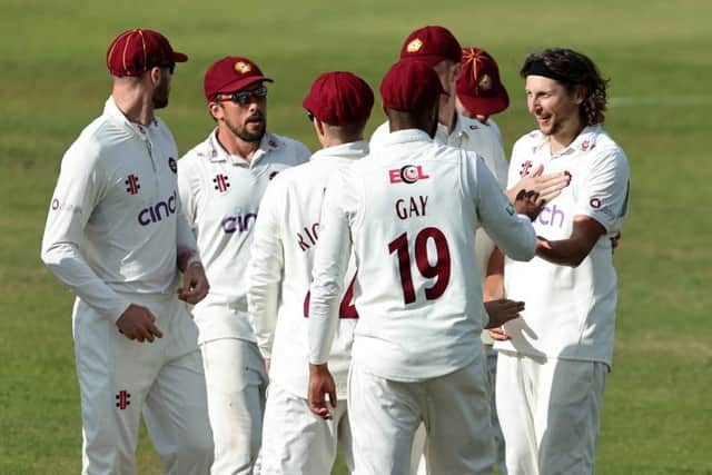 The Northants players celebrate after Jack White claimed the wicket of Alex Davies