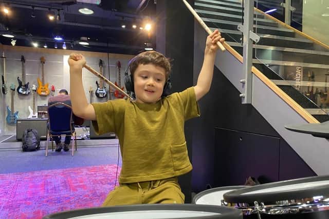 Boy learning to play drums