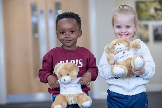 BN - SGB-7908 - Two children from Priors Hall Nursery holding their brand new bears
