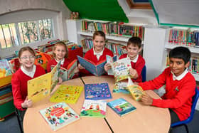 DWSM - SGB-19953 - Pupils at Wilby C of E Primary School with the books donated by David Wilson Home