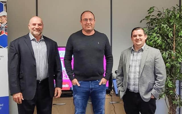 HR Solutions CEO Greg Guilford, centre, with Pulse Group Media’s Martin Lewis-Stevenson, left, and Q