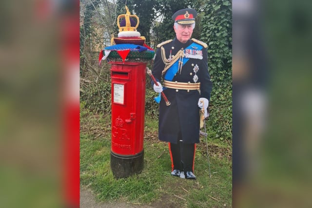 King Charles III next to a post box in Higham Ferrers