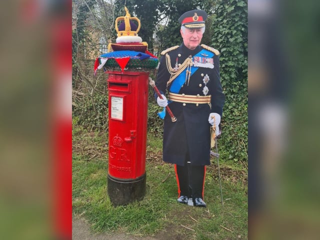 King Charles III next to a post box in Higham Ferrers