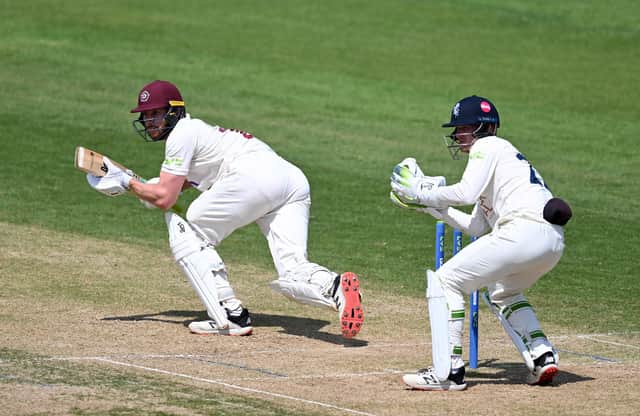 Rob Keogh plays a shot as Kent wicketkeeper Jordan Cox looks on (photo by Shaun Botterill/Getty Images)