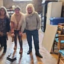 Rev Tom Houston (left) with fellow fundraisers and the wooden floor