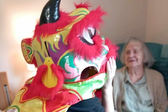 A resident looks on in amusement at the Chinese dragon.