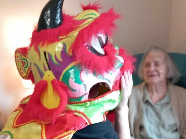A resident looks on in amusement at the Chinese dragon.