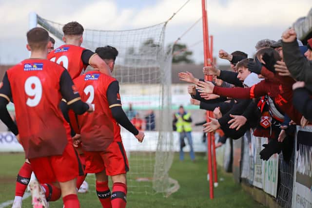 The Kettering Town players and fans celebrate Frankie Maguire's winning goal in the 1-0 success over Brackley Town. Picture by Peter Short