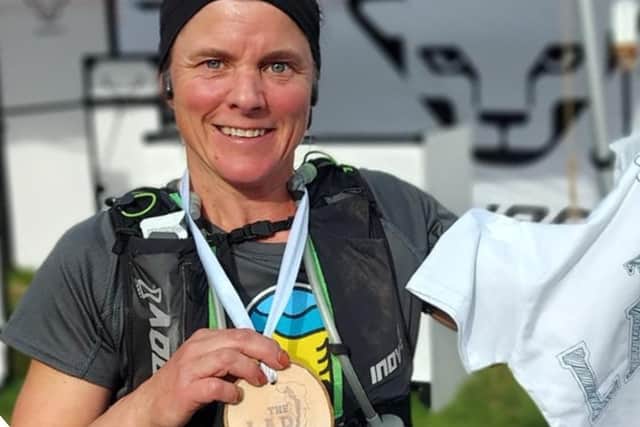 Lynne photographed with her finishers medal.