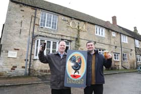 L-r Jayme Bent (landlord) and owner Gareth Williams toast the takeover of the Cock Inn, Denford
