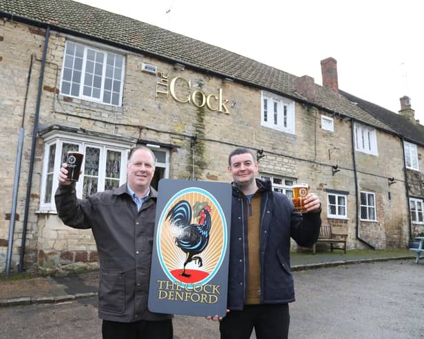L-r Jayme Bent (landlord) and owner Gareth Williams toast the takeover of the Cock Inn, Denford