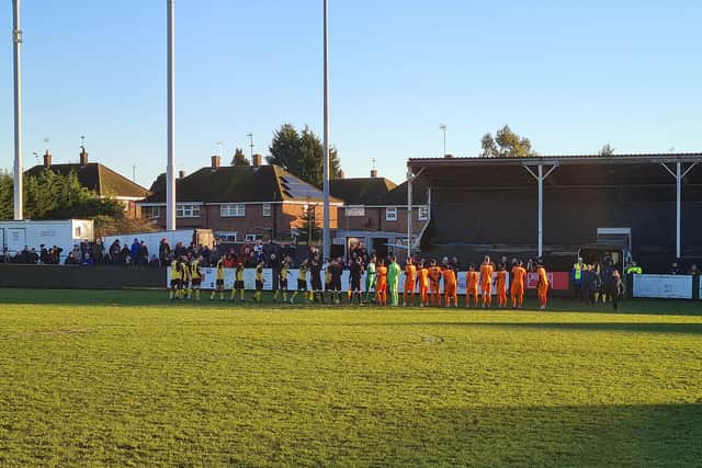 The AFC Rushden & Diamonds and St Ives Town players exchange pleasantries ahead of their Bank Holiday Monday clash at Hayden Road