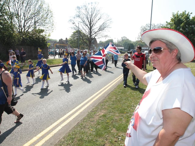 Rushden St Georges Day parade: Linda Whitfield, waves the parade by. 2011