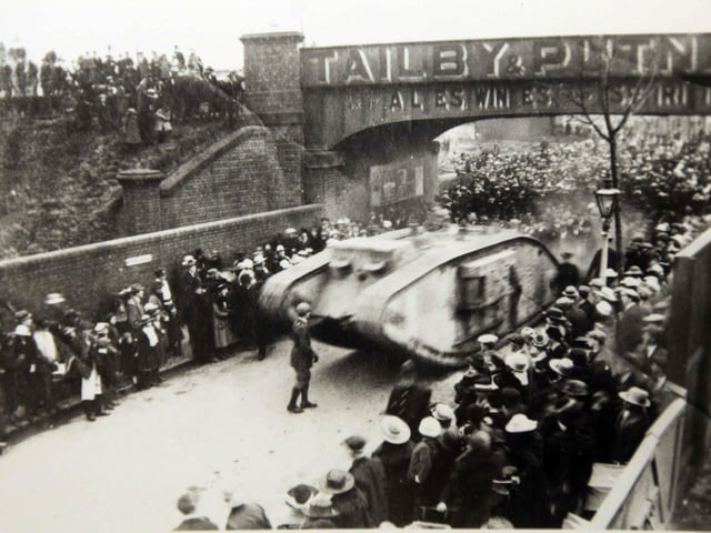 At the end of the First World War, a tank arrives in Rushden. It is seen here in 1919 or 1920 underneath the bridge which used to stand near where Asda is today