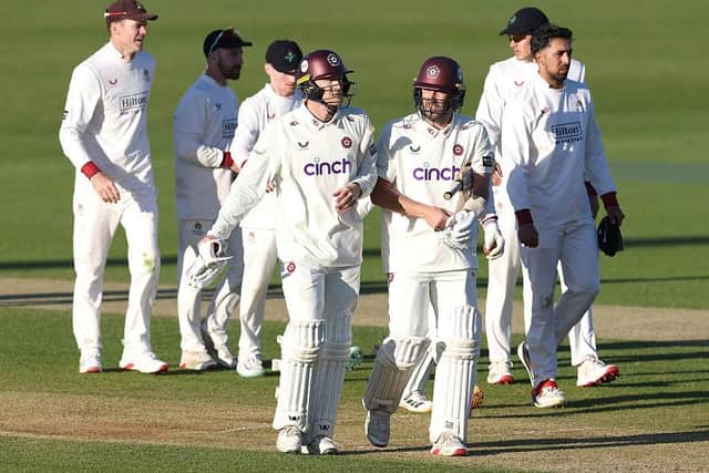 George Bartlett (left) and Ben Sanderson walk off the pitch after guiding Northants to a draw against Lancashire (Photo by David Rogers/Getty Images)