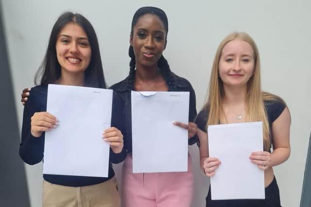Lara Silva, Ewa Ogedengbe and Jessica Routledge celebrate at Kingswood Secondary Academy