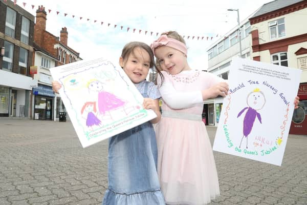 l-r Tate and Liliana with their posters that are decorating Kettering town centre