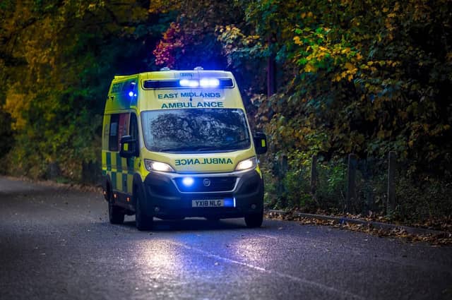 An East Midlands ambulance travelling with blue lights on.