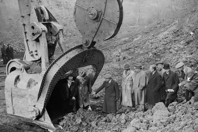 2nd November 1934: Men emerge from the  fifteen ton scoop of Europe's biggest digger at Corby