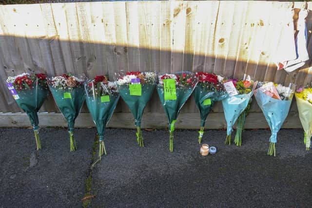 Friends of the family left floral tributes at the scene in Petherton Court. Image: Joseph Walshe / SWNS