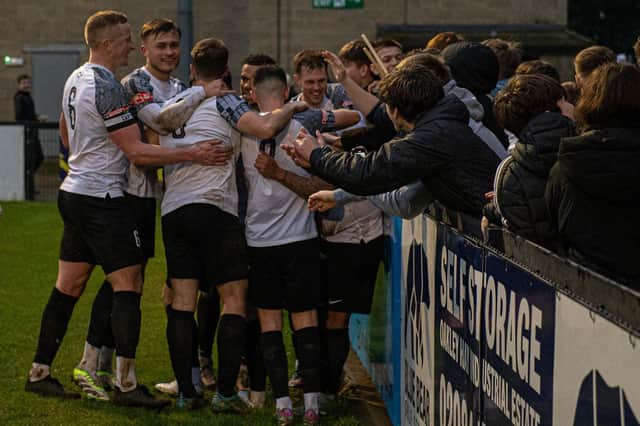 Corby Town's players celebrate Greg Mills netting his late penalty to seal the 1-0 win over Hinckley LRFC on Saturday (PIcture: Jim Darrah)