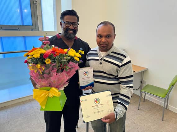 Prof Ganesh Baliah presents the award to Clinical Operations Clinical Support Worker Asmanansing Manick.