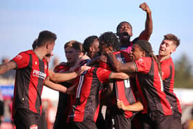 Nile Ranger is mobbed by his Kettering Town team-mates after scoring his stoppage time penalty (Picture: Peter Short)