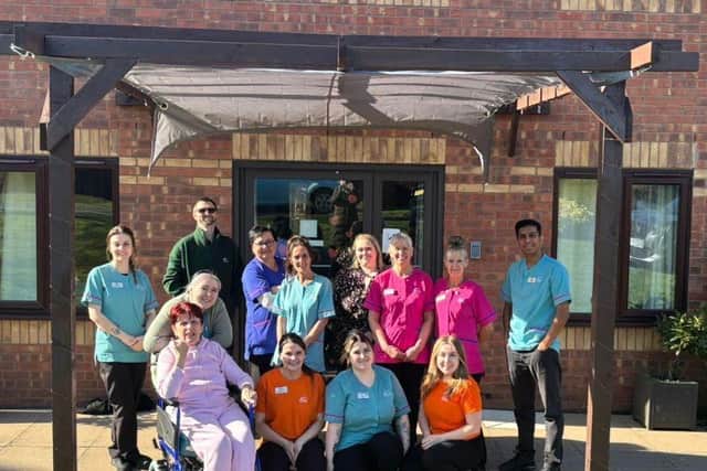 Residents and staff under the newly built pergola
