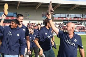 Shoes off if you love the town... Darren Lehmann and the Steelbacks squad enjoyed their lap of honour at Sixfields on Saturday (Picture: Pete Norton/Getty Images)