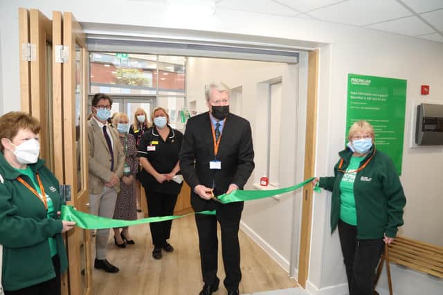 Official opening ceremony for the new Macmillan Cancer Support Centre at Kettering General Hospital = Earl Spencer cuts the ribbon held by fundraisers Suzanne Williams and Wendy Asbery volunteers from the Macmillan Rose of the Shires committee