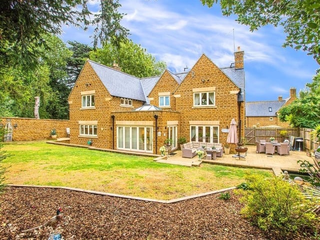 This modern family home is in a picturesque village and shares its boundary with a church.