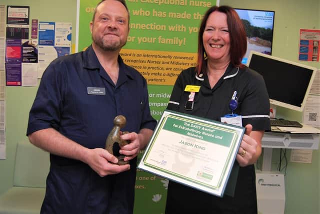 Emergency Nurse Jason King is presented with his award by Deputy Chief Nurse Pam Smith