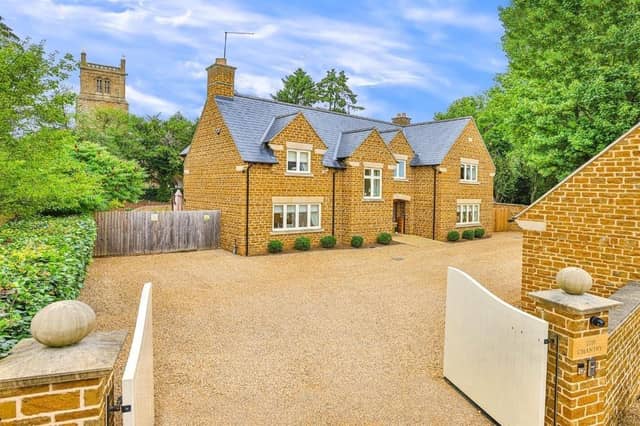 This modern family home is in a picturesque village and shares its boundary with a church.