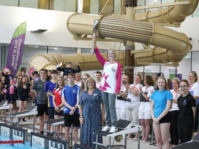 Rebecca Johnson holds up the baton