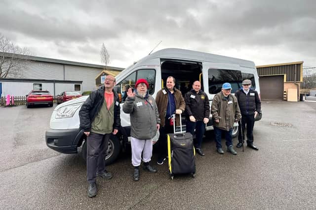 Service users outside their coach on holiday