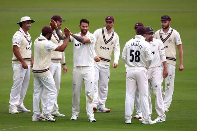 Jordan Clark of Surrey celebrates with team mates after taking the wicket of Ricardo Vasconcelos