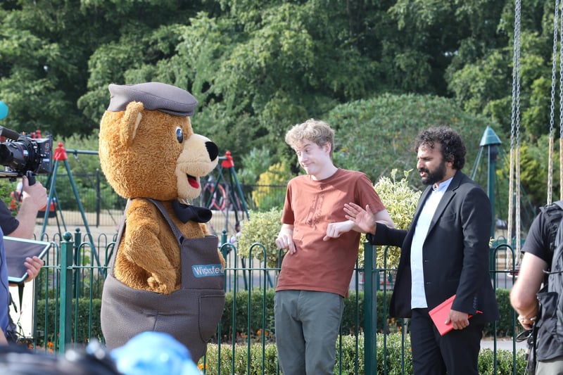Nish Kumar and James Acaster filiming at Wicksteed Park with Wicky Bear and a goat named after James in August 2022.